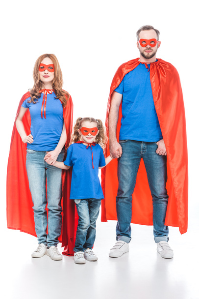 family of superheroes holding hands and looking at camera isolated on white - Фото, зображення