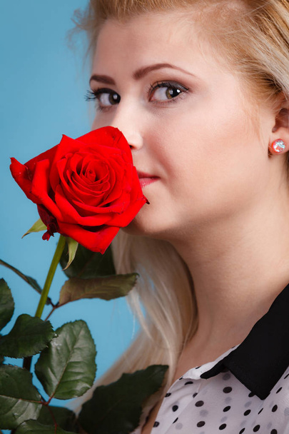 Gorgeous woman holding red rose flower. - Фото, зображення