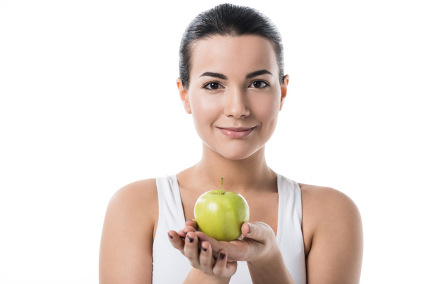 beautiful girl holding ripe apple and looking at camera isolated on white - Φωτογραφία, εικόνα