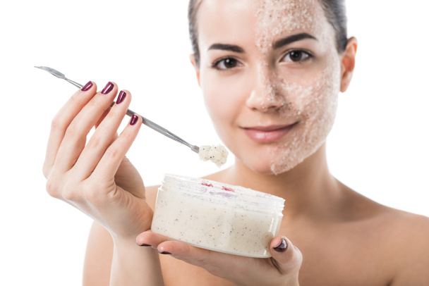 beautiful girl taking facial scrub from jar isolated on white - Foto, Bild