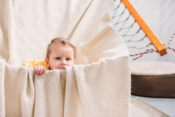 Portrait of little boy laying in rope hammock  - Zdjęcie, obraz
