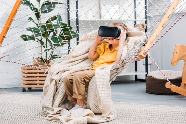 Boy in rope hammock using virtual reality headset - Zdjęcie, obraz