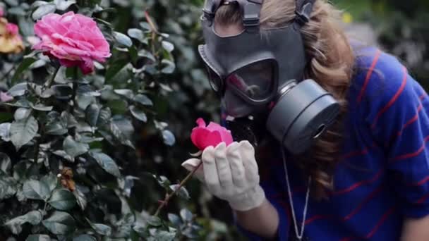 Girl in gas masks smells roses - Footage, Video