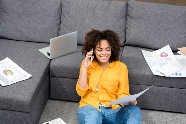 happy young woman sitting on floor at home and working - Photo, Image