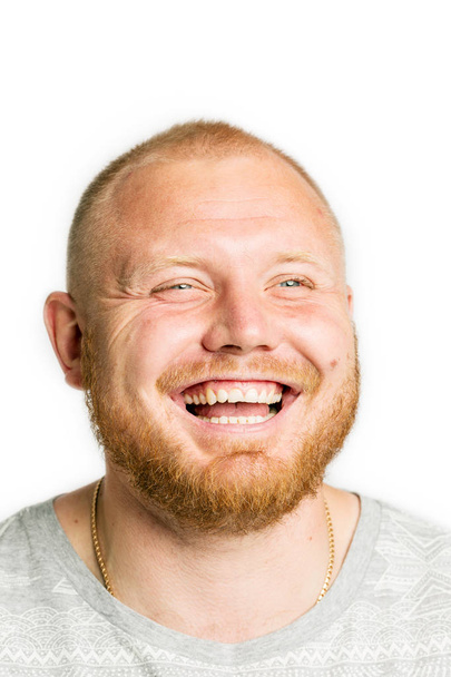 Cute young man with a beard laughing, close-up, isolated - Foto, afbeelding