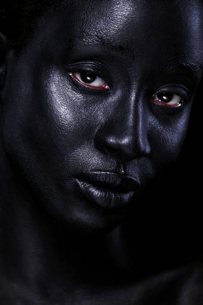 Cheerful young african woman with art fashion makeup. An amazing woman with black bodyart - Valokuva, kuva