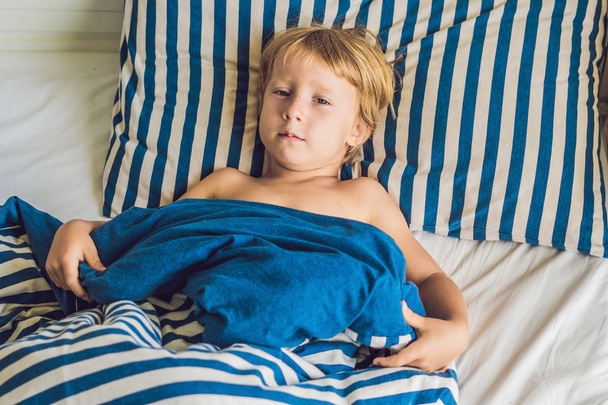 The cute boy woke up in his bed. Children sleep concept. - Fotó, kép