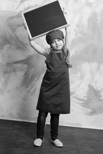 smiling kid, happy girl cook in red chef hat, apron - 写真・画像