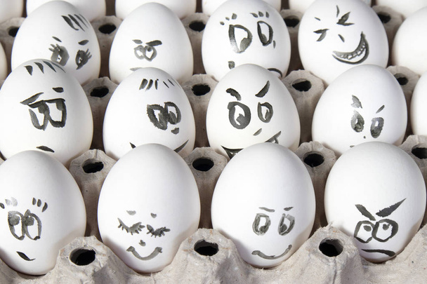 the Hen eggs in box. Eggs cover with drawings. Look like man face - Foto, Imagen