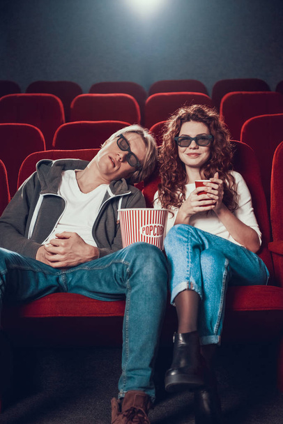 Guy and woman are sitting and watching a movie - Zdjęcie, obraz