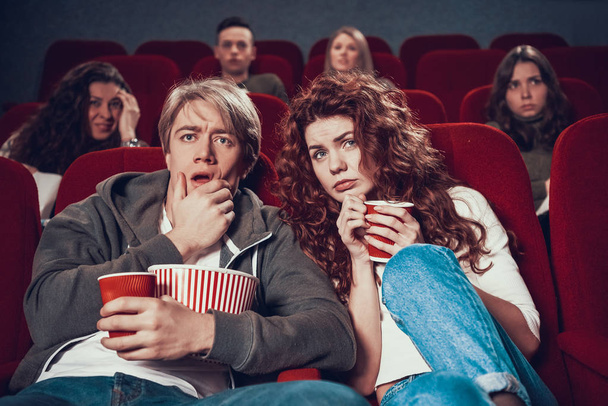 People sit in the cinema and watch movie together. - Zdjęcie, obraz