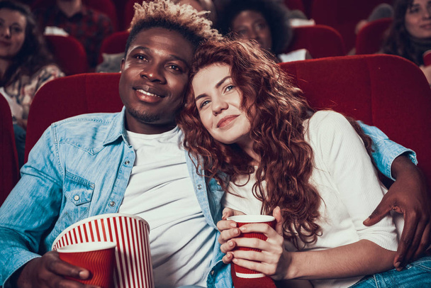 Black man hugging woman and watching movie.  - Photo, image