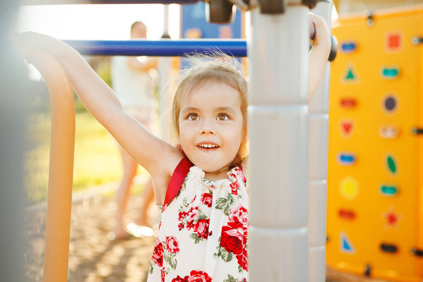 little happy girl playing on playground. - Foto, Imagen