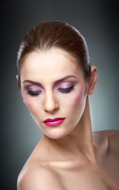 Professional make up - beautiful female art portrait with beautiful eyes. Elegance. Genuine natural woman in studio. Portrait of a attractive woman with red lips and creative make up  - Фото, изображение