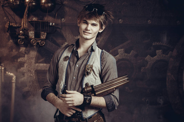 Portrait of a young man with a gun. - Foto, afbeelding