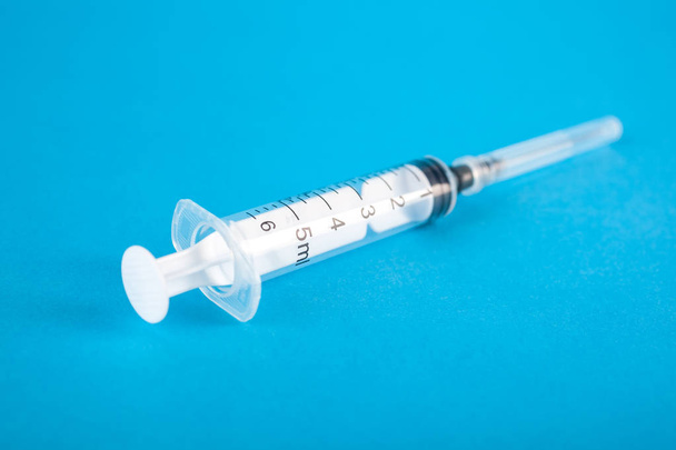 standard design single use syringe isolated on blue background - Photo, Image