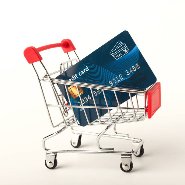 Shopping cart with credit card isolated on white background - Fotoğraf, Görsel