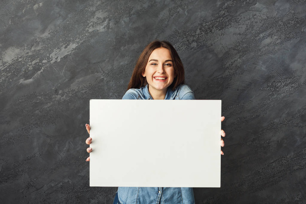 Young woman holding blank white banner - Photo, image