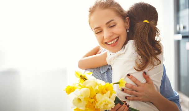 happy mother's day! child daughter   gives mother a bouquet of f - Fotografie, Obrázek