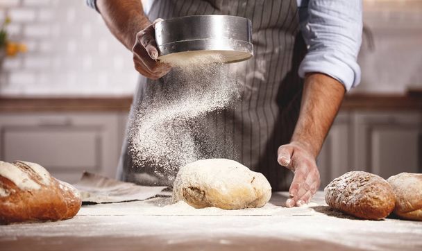 hands of baker's male knead dough - Photo, Image