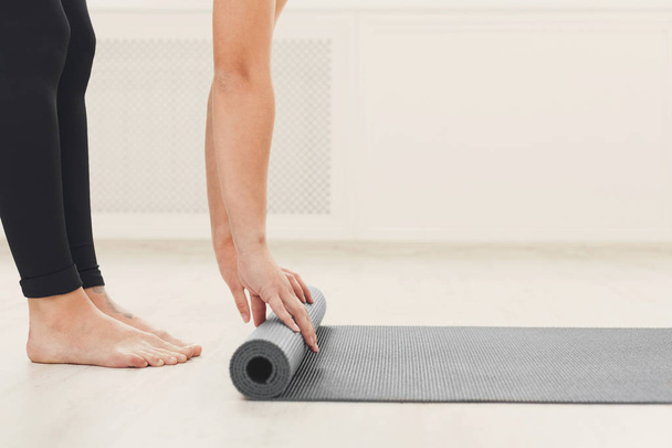 Rolling up fitness mat for exercise copy space - Photo, Image