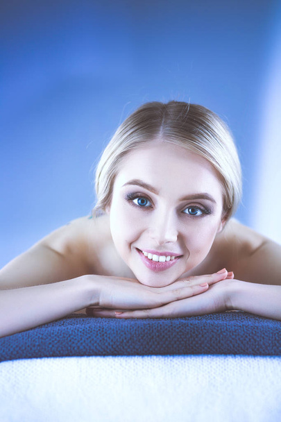 Young woman lying on a massage table,relaxing . Woman. Spa salon - 写真・画像