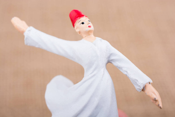 Hand holding a white color Sufi Dervish figurine in hand - Photo, Image