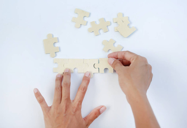 Hands connecting jigsaw puzzle isolated on white background - Photo, Image