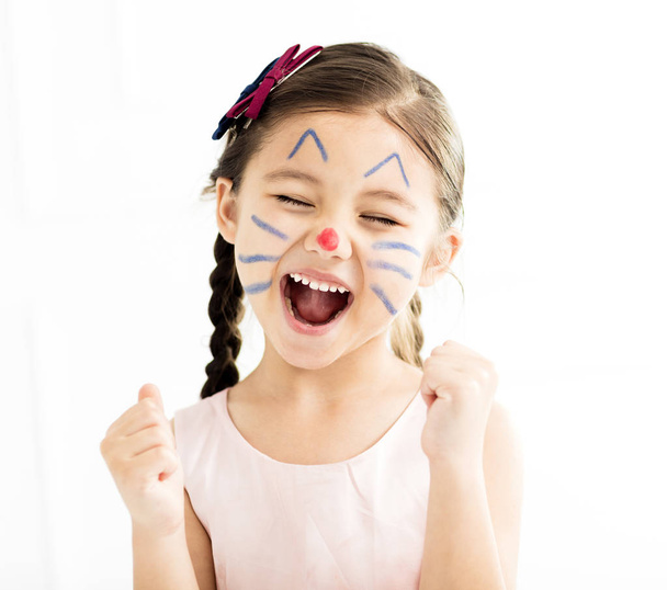happy little girl with kitty painted face - Foto, imagen