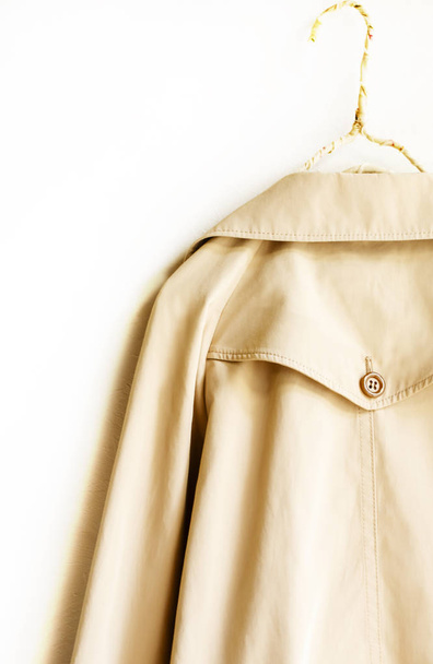 the back of a beige elegant trench coat isolated over white - Photo, Image