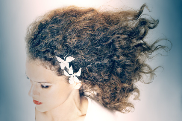 Curly hair elegant woman hairstyle - 写真・画像