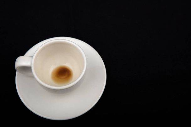 Empty coffee cup on black background - 写真・画像