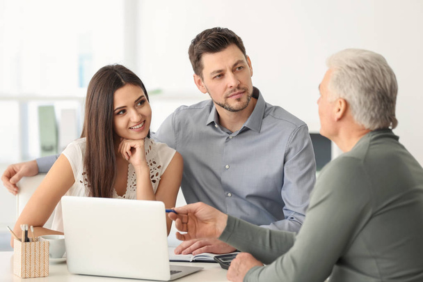 Young couple discussing pension plan with consultant in office - Foto, Imagem