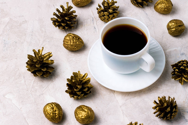Cup of black coffee and Gold Cones on a light background. Winte - Photo, Image
