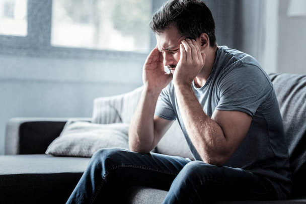 Depressed young man suffering from migraine - Fotografie, Obrázek
