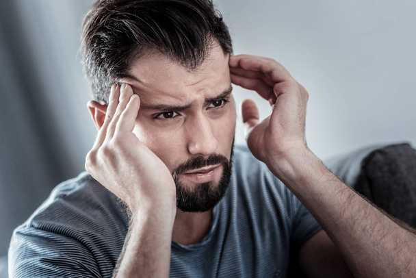 Depressed unhappy man having a headache - Фото, зображення