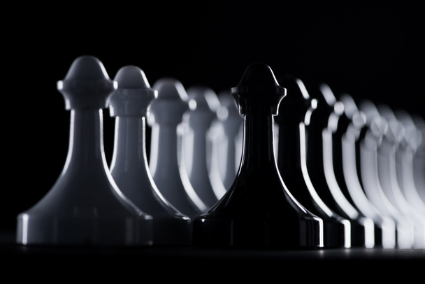 rows of white and black chess figures isolated on black, business concept - Photo, Image