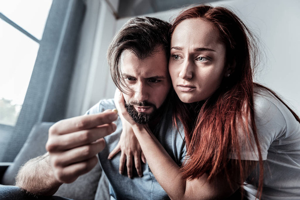 Unhappy young woman hugging her boyfriend - Фото, зображення