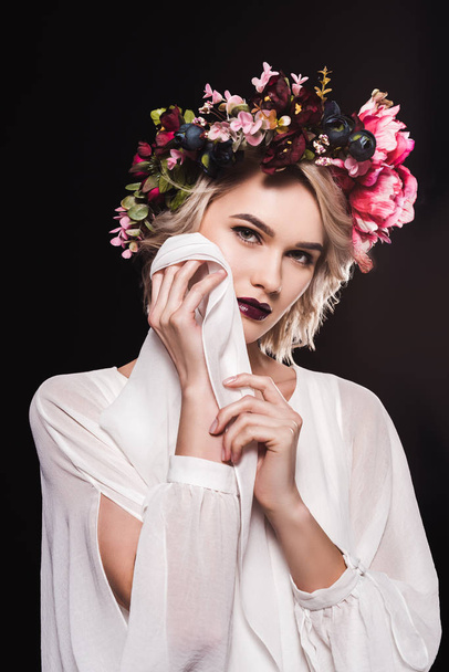 fashionable blonde girl posing in white dress and flower wreath, isolated on black - Fotografie, Obrázek
