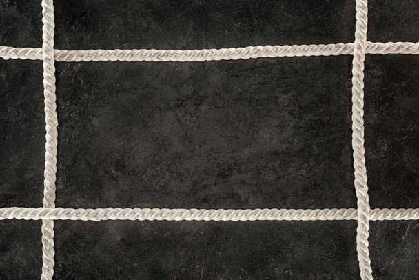 top view of arranged white marine ropes on dark concrete tabletop - Fotoğraf, Görsel