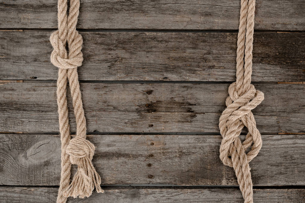 flat lay with marine ropes with knots on grunge wooden tabletop - Photo, Image