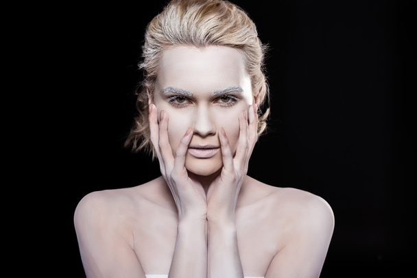 attractive young woman posing with white makeup, isolated on black - Zdjęcie, obraz