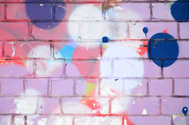 Close-up fragment of a graffiti drawing applied to the wall by aerosol paint. Background image of a modern composition of lines and colored areas. Street art concept - Photo, Image