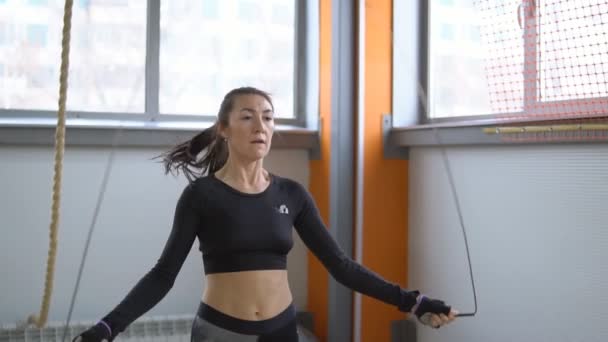 Woman is jumping rope in the gym. The concept of a healthy lifestyle - Footage, Video