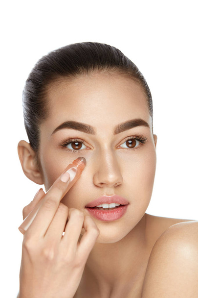 Eye Skin Care. Beautiful Woman Using Cream - Fotó, kép