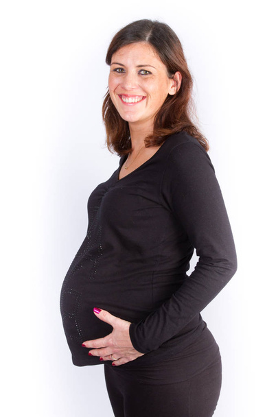 Beautiful pregnant woman isolated over a white background - Fotó, kép