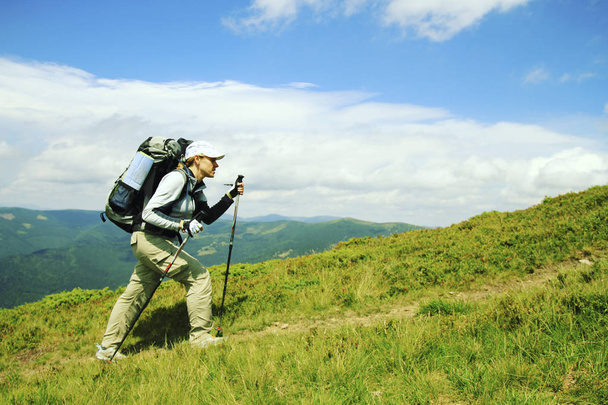 Summer hike in the mountains with a backpack and tent. - 写真・画像
