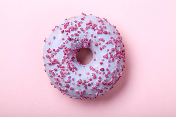 sweet glazed raspberry donut on pink background, close-up  - Zdjęcie, obraz
