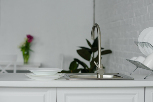 water tap and sink at light modern kitchen - Fotó, kép