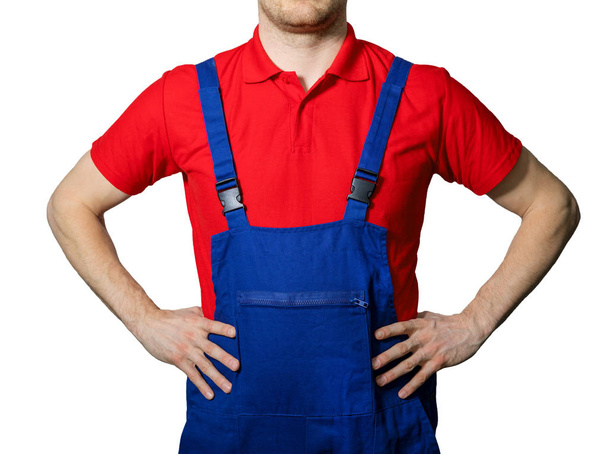 worker in blue overalls and red polo shirt isolated on white bac - Photo, Image